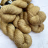 Hand dyed yarn. Medium gold, semi solid, hand dyed yarn on Merino Silk Yak fingering weight 4 ply yarn.